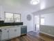 Bright kitchen featuring white cabinets, stainless steel appliances, and wood flooring at 11937 Claude Ct, Northglenn, CO 80233