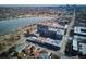 Aerial view features condo building adjacent to lake and city in the distance at 4200 W 17Th Ave # 223, Denver, CO 80204