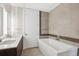Bathroom showcasing a modern tub with stylish tile work and double vanity at 4200 W 17Th Ave # 223, Denver, CO 80204