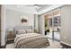 Serene bedroom with neutral tones, a comfortable bed, and a view of the balcony at 4200 W 17Th Ave # 223, Denver, CO 80204