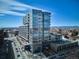 Modern glass condo building with mountain views, balconies, and nearby walkable retail at 4200 W 17Th Ave # 223, Denver, CO 80204
