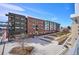Community courtyard and apartments with balconies on a bright day at 4200 W 17Th Ave # 223, Denver, CO 80204