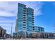 Contemporary high-rise condo with glass facade, balconies, and street-level retail at 4200 W 17Th Ave # 223, Denver, CO 80204
