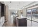 Contemporary kitchen with a center island, modern appliances, and sliding doors leading to a balcony at 4200 W 17Th Ave # 223, Denver, CO 80204