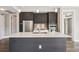 Modern kitchen featuring stainless steel appliances, a center island with seating, and sleek cabinetry at 4200 W 17Th Ave # 223, Denver, CO 80204