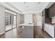 Bright kitchen with an island, stainless steel appliances, and sliding glass doors leading to a balcony at 4200 W 17Th Ave # 223, Denver, CO 80204