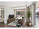 Cozy living room with stylish furniture, a large window, and a view of the outdoor seating area at 4200 W 17Th Ave # 223, Denver, CO 80204