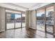 Bright living room featuring hardwood floors, large windows, and access to a private balcony at 4200 W 17Th Ave # 223, Denver, CO 80204
