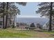 Backyard view featuring a hot tub and seating with a beautiful view of the city in the distance at 21531 Main Ave, Golden, CO 80401