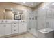 Bright bathroom featuring a double vanity, marble shower, and tile flooring at 21531 Main Ave, Golden, CO 80401