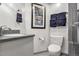 Bathroom featuring a framed sailing-themed print above a toilet, adjacent to towel racks and a partially visible shower at 21531 Main Ave, Golden, CO 80401
