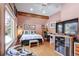 Cozy bedroom with hardwood floors, a ceiling fan, and a window overlooking the outdoors at 21531 Main Ave, Golden, CO 80401