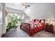 Bright bedroom with large windows, a cozy ceiling fan, and eye-catching red quilt at 21531 Main Ave, Golden, CO 80401