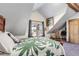 Bright bedroom with sloped ceilings, large window, and wood accents at 21531 Main Ave, Golden, CO 80401