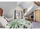 Comfortable bedroom with wooden accents and a large window overlooking the outdoors at 21531 Main Ave, Golden, CO 80401