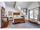 Cozy bedroom featuring wood furnishings, a comfortable bed, and a sloped ceiling at 21531 Main Ave, Golden, CO 80401