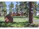 Beautiful home with mature trees and prominent stone address marker at 21531 Main Ave, Golden, CO 80401