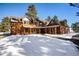 Mountain home exterior; log siding, multiple dormers, covered porch at 21531 Main Ave, Golden, CO 80401