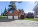 Two car garage and spacious front yard of home with a long covered front porch at 21531 Main Ave, Golden, CO 80401
