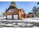 Two-car garage and log home exterior with snow at 21531 Main Ave, Golden, CO 80401