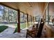 Charming covered front porch with stone flooring and rustic wooden columns providing a welcoming outdoor space at 21531 Main Ave, Golden, CO 80401