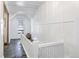 Hallway with white wall panels and tiled floor leading to a glass door with outside view at 21531 Main Ave, Golden, CO 80401