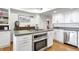 Modern kitchen with island, stainless steel appliances, and white cabinetry at 21531 Main Ave, Golden, CO 80401