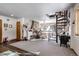 Spacious living room featuring a stone fireplace and spiral staircase at 21531 Main Ave, Golden, CO 80401
