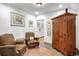 Cozy living room with wood armoire, seating and unique artwork, creating a relaxing ambiance at 21531 Main Ave, Golden, CO 80401