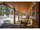 Relaxing covered porch with rocking chairs and mountain views at 21531 Main Ave, Golden, CO 80401