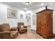 Cozy sitting area features two comfy armchairs and a wooden cabinet at 21531 Main Ave, Golden, CO 80401