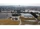 Aerial view of community pool with a clubhouse, playground, and parking area in a snowy landscape at 24747 E Calhoun Pl # C, Aurora, CO 80016