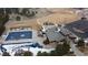 Aerial view of the community pool, clubhouse, playground, and parking area in a snowy landscape at 24747 E Calhoun Pl # C, Aurora, CO 80016