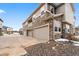Modern townhome featuring a stone and siding facade with attached garages and a well-maintained landscape at 24747 E Calhoun Pl # C, Aurora, CO 80016
