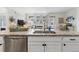 Spacious kitchen island featuring a granite countertop, stainless steel sink, and seating at 24747 E Calhoun Pl # C, Aurora, CO 80016