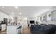 Open-concept living room with modern kitchen, a large island, stainless steel appliances, and a comfortable seating area at 24747 E Calhoun Pl # C, Aurora, CO 80016