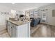 Open-concept kitchen and living room featuring modern finishes and natural light at 24747 E Calhoun Pl # C, Aurora, CO 80016
