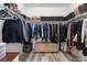 Organized walk-in closet with ample shelving, hanging space, and a bench for convenience at 24747 E Calhoun Pl # C, Aurora, CO 80016