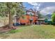 Spacious backyard features a patio with a pergola and seating area at 209 10Th Ave, Idaho Springs, CO 80452