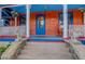 Inviting front porch with colorful decorations and ornate railing at 209 10Th Ave, Idaho Springs, CO 80452