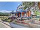 Charming home featuring a colorful exterior, inviting front porch, and tiered garden beds at 209 10Th Ave, Idaho Springs, CO 80452