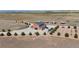 Aerial view of a property featuring a brick building with car and truck parking and surrounding fields and trees at 12565 Picadilly Rd, Commerce City, CO 80022