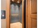 Unique elevator with textured wall and wooden accents at 12565 Picadilly Rd, Commerce City, CO 80022