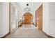 Elegant entryway with custom lighting, wood accents, and tile flooring at 12565 Picadilly Rd, Commerce City, CO 80022