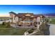 Custom home featuring a turret, multiple balconies, and lush landscaping at 12565 Picadilly Rd, Commerce City, CO 80022