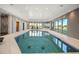 Luxurious indoor pool with spa, ample seating, and natural light at 12565 Picadilly Rd, Commerce City, CO 80022