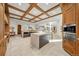 Open eat-in kitchen with gray cabinets, modern appliances, and coffered ceilings at 12565 Picadilly Rd, Commerce City, CO 80022