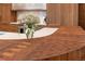 Close up of the kitchen island featuring a butcher block countertop at 12565 Picadilly Rd, Commerce City, CO 80022