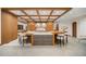 Spacious eat-in kitchen with a coffered ceiling, large center island with stools, and modern countertops at 12565 Picadilly Rd, Commerce City, CO 80022