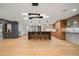 Modern kitchen with sleek island, wood floors, and contemporary lighting at 12565 Picadilly Rd, Commerce City, CO 80022